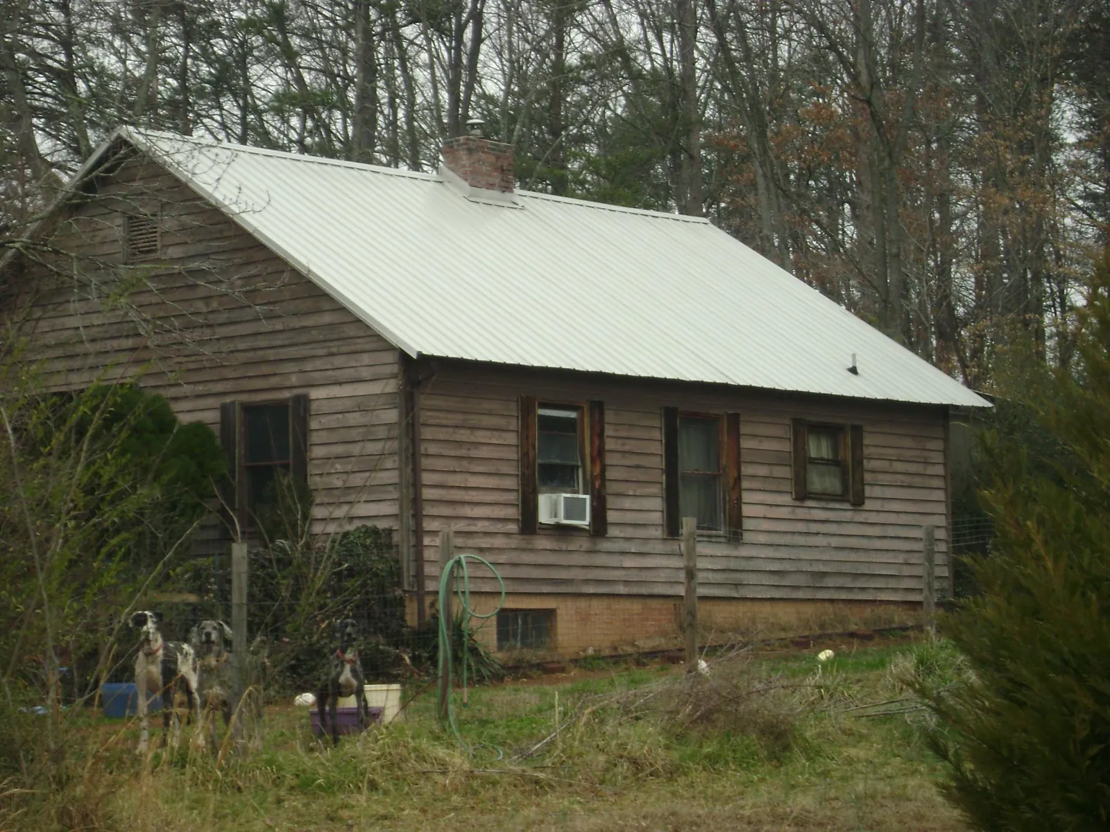 White metal roof on an old wood sided farmhouse, from a Metal Roof Installation job in Huntington